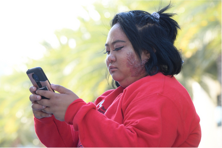 A photo of a survivor on a phone