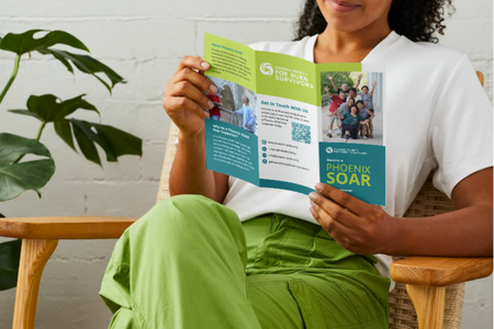 A photo of a woman looking a brochure. 