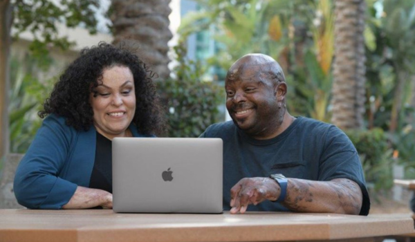 Two burn survivors on a computer