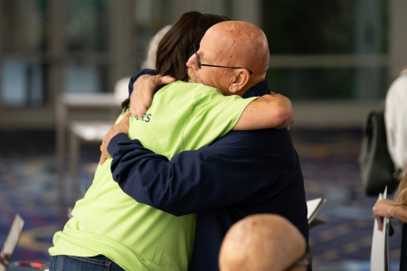 A photo of two survivors hugging.